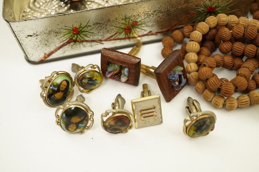 A small collection of costume jewellery, a Christian Dior golf club tie clip, a pair of simulated pearl screwback earrings, stamped 9ct, an Indian silver locket, assorted cufflinks etc